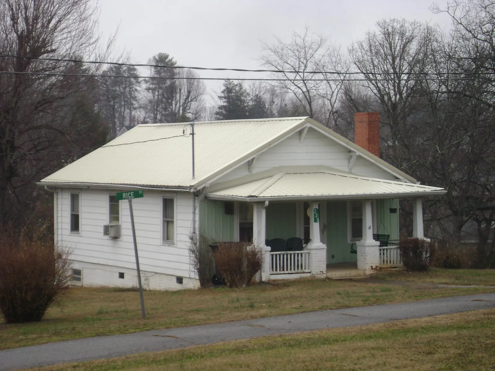 White metal roof on a craftsman bungalow at a street corner in Missouri City